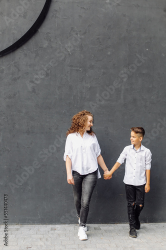 cheerful smiling boy walks with his mother