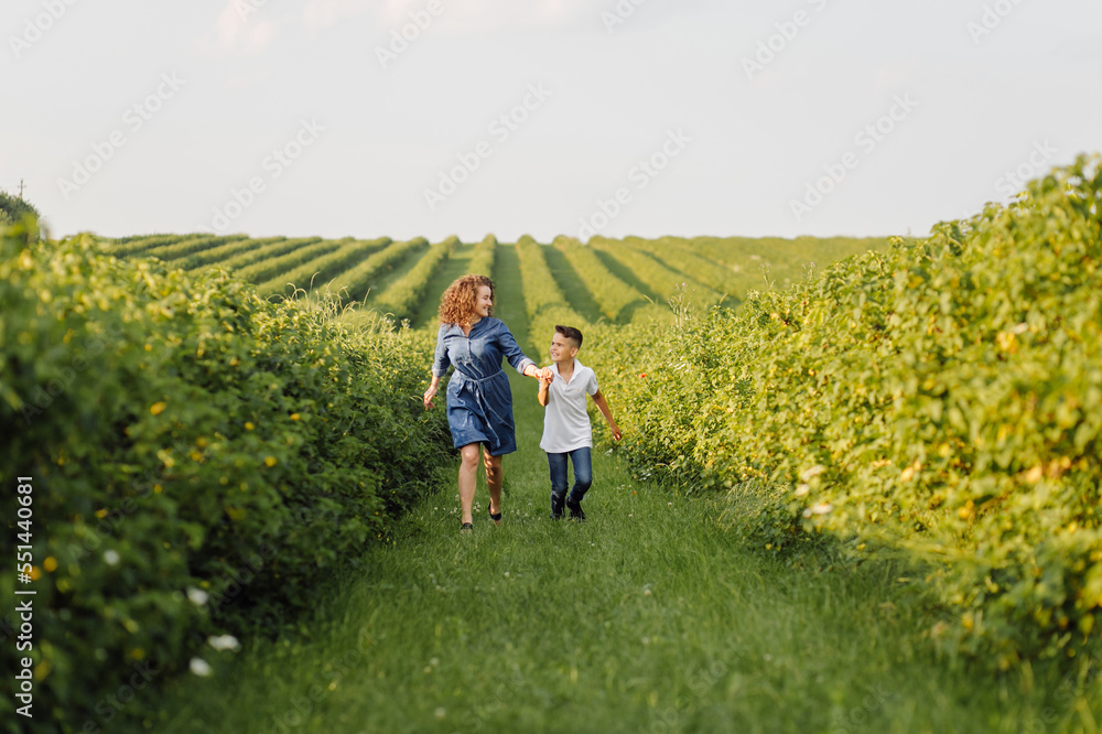 Young family looking at the camera while walking in the garden