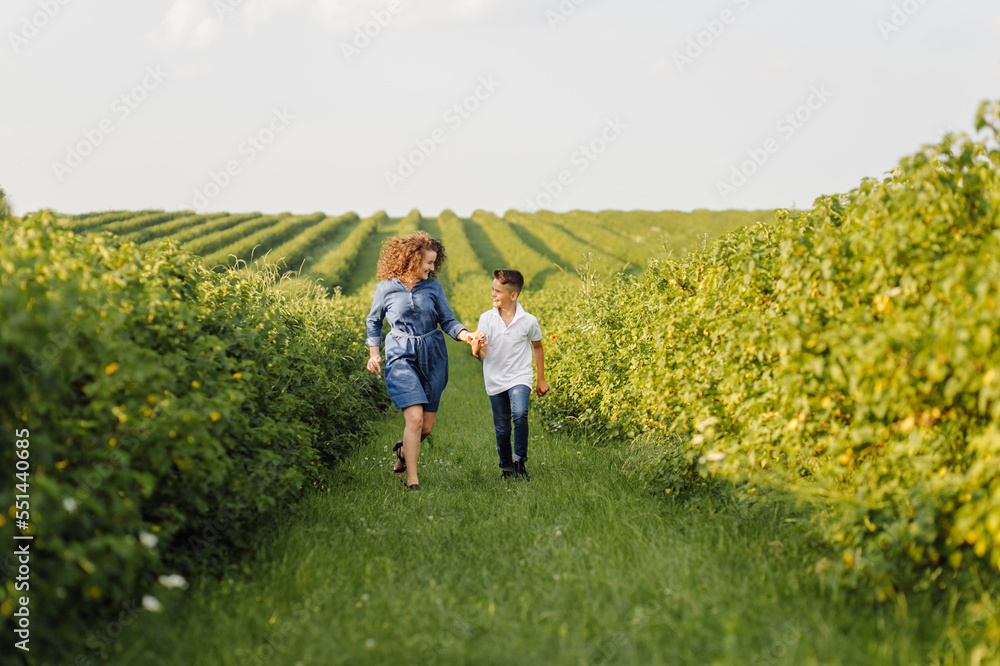 Young family looking at the camera while walking in the garden