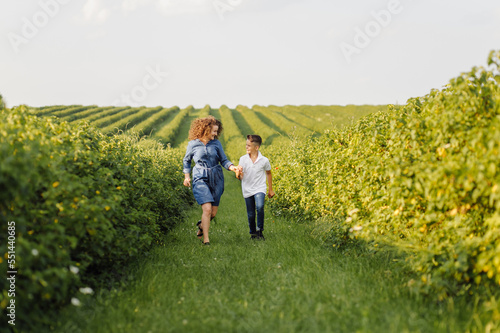 Young family looking at the camera while walking in the garden