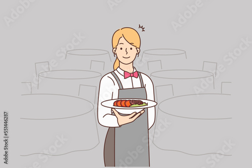 Smiling waitress serving meal in restaurant 