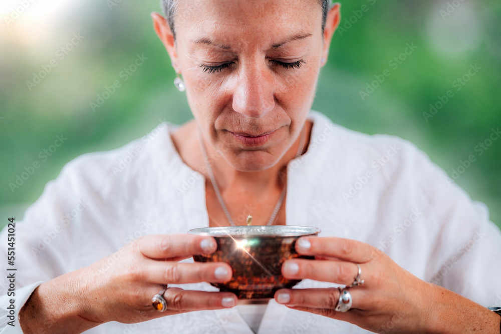 Spiritually awaken woman practicing mindfulness, infusing intention into her morning tea Spiritually awaken woman practicing mindfulness, infusing intention into her morning tea
