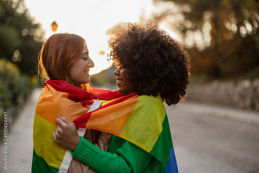 Multiracial Lesbian Couple Look At Each Other With Love Embracing With