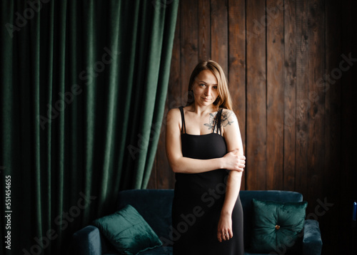 Portrait of gorgeous female brunette model posing in white fashion clothes in studio