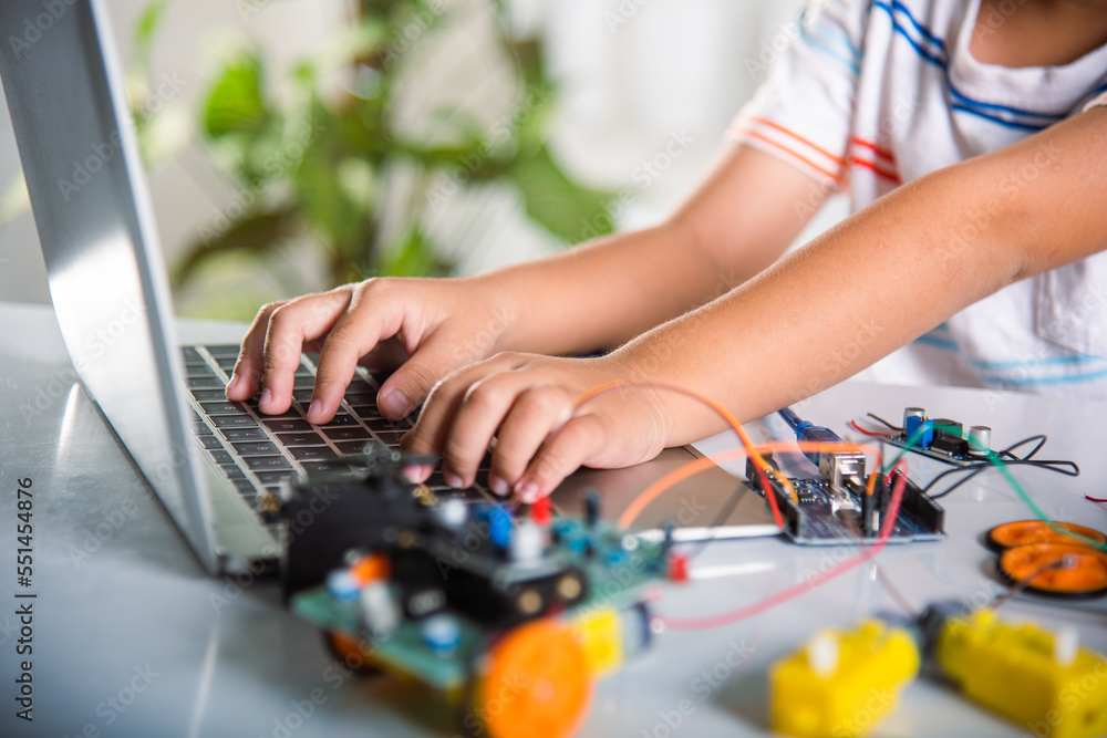 Foto de Asian kid boy learns coding and programming with laptop for ...