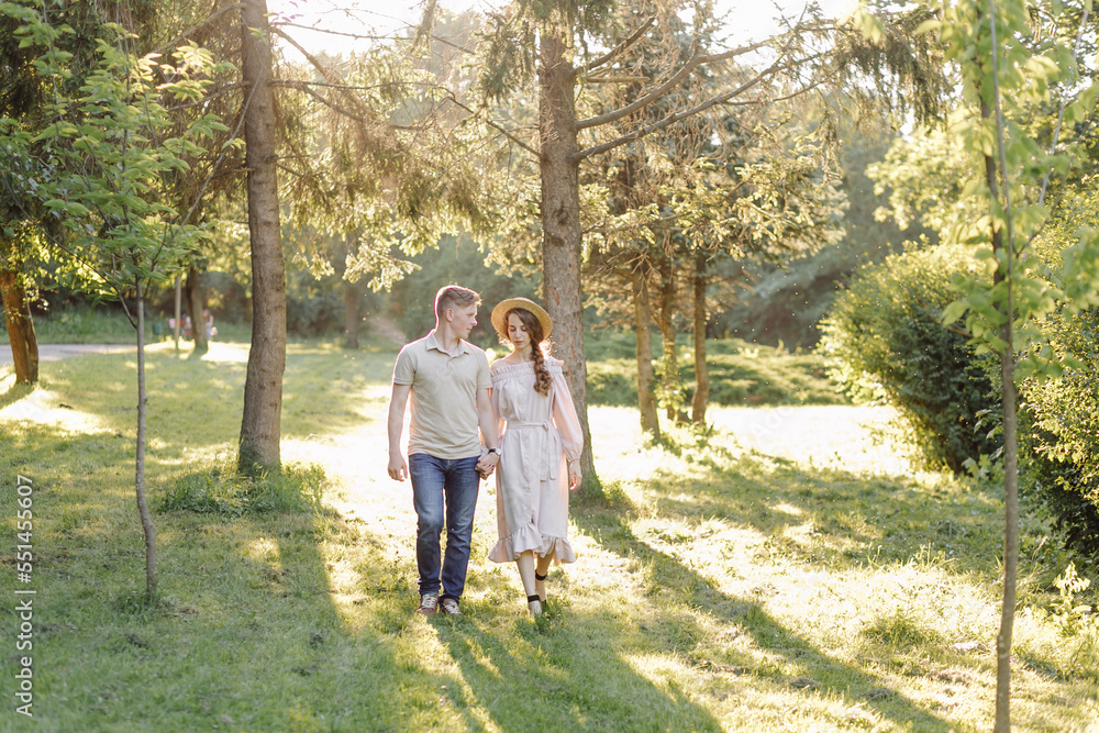 Young couple in love outdoor.Stunning sensual outdoor portrait of young stylish fashion couple posing in summer in field Young couple in love outdoor.Stunning sensual outdoor portrait of young stylish fashion couple posing in summer in field