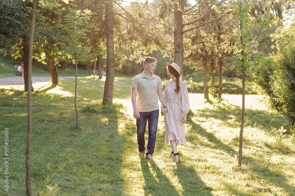 Young couple in love outdoor.Stunning sensual outdoor portrait of young stylish fashion couple posing in summer in field Young couple in love outdoor.Stunning sensual outdoor portrait of young stylish fashion couple posing in summer in field