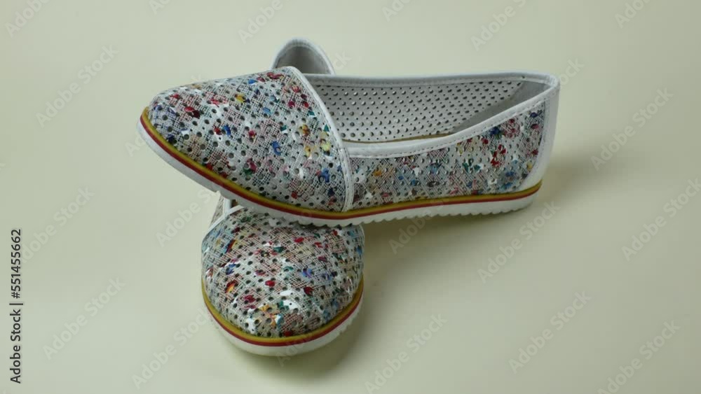 Female summer slippers with a beautiful motley pattern. A pair of beautiful light summer shoes female. Modern summer female shoes for walking outside the home Female summer slippers with a beautiful motley pattern. A pair of beautiful light summer shoes female. Modern summer female shoes for walking outside the home