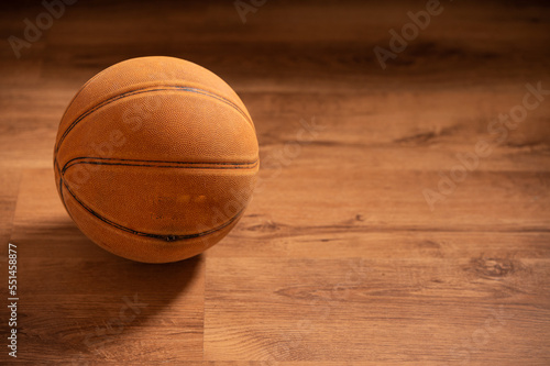 Close up shot of basketball on wooden floor