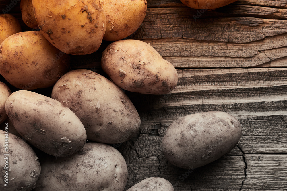 Potatoes on wooden planks food still life background Potatoes on wooden planks food still life background