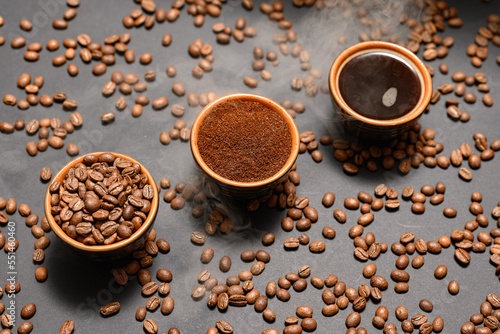 Three cups with different coffee  coffee beans  ground and ready-made drink.