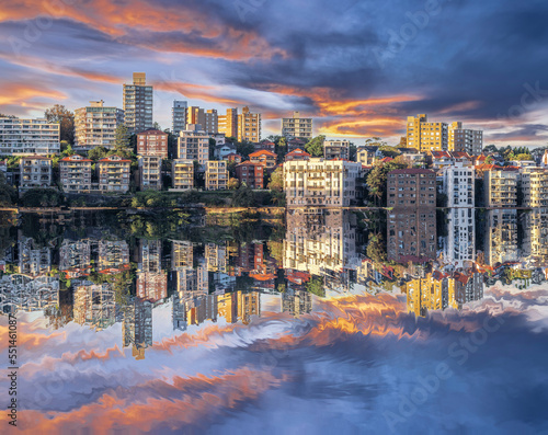 Sydney Harbour Australia at Sunset with the reflection of the Buildings and high rise offices of the City in the water