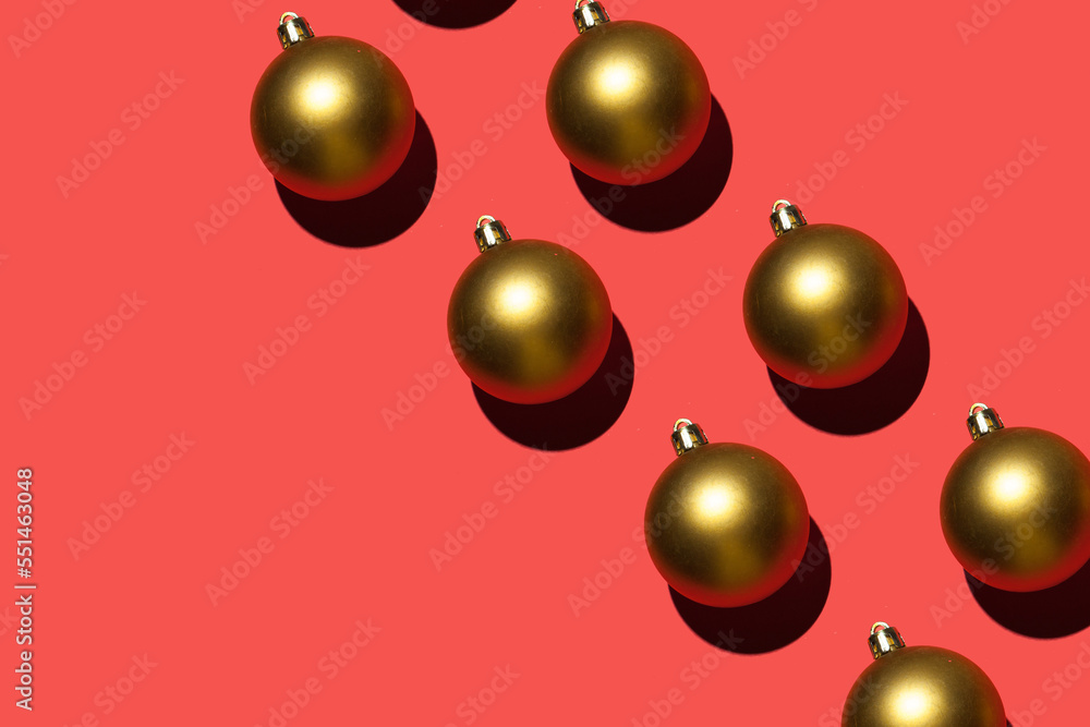shiny golden christmas balls decoration pattern on red background shiny golden christmas balls decoration pattern on red background