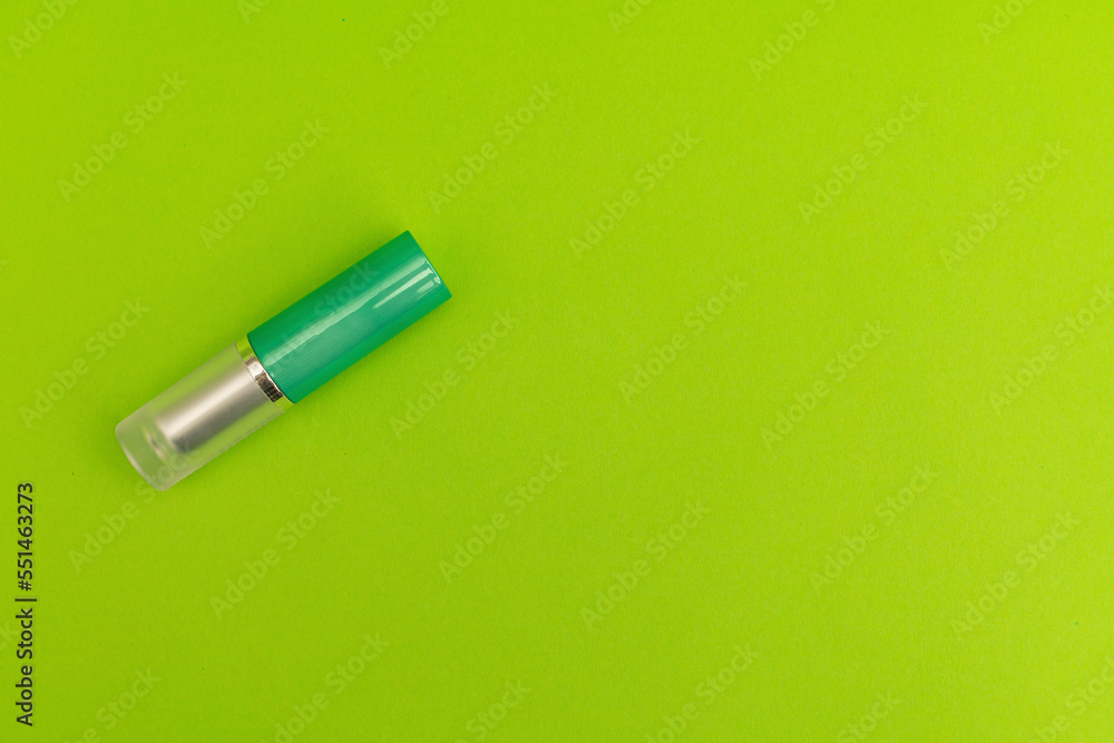 Green lipstick on green background, monochrome Green lipstick on green background, monochrome