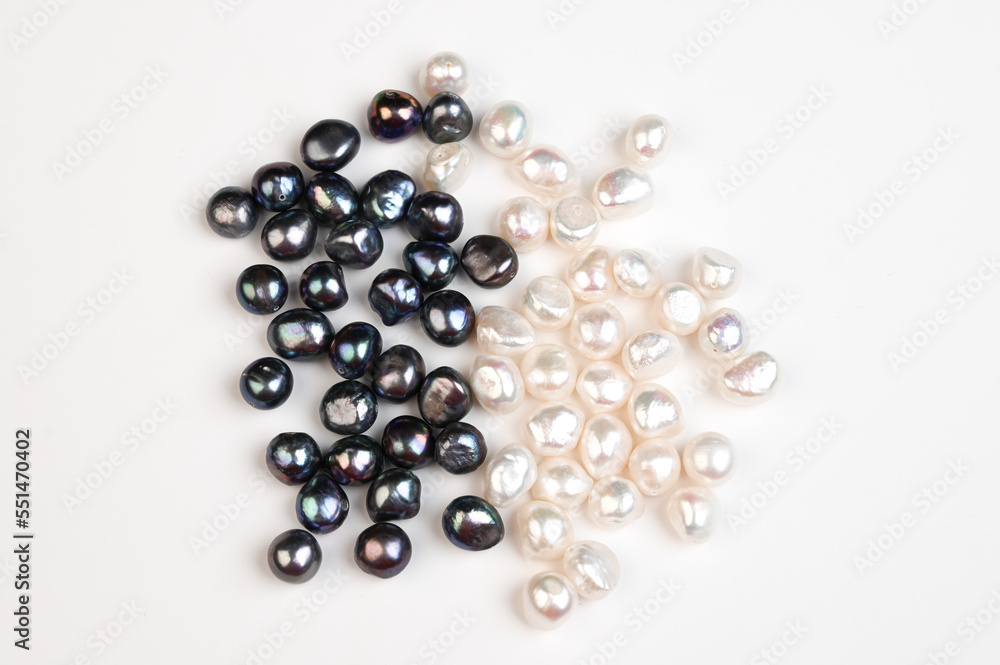 Black and white pearl on white background top view. Natural freshwater pearls Black and white pearl on white background top view. Natural freshwater pearls