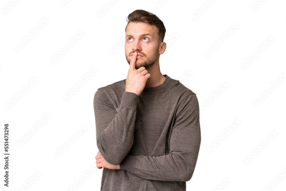 Young handsome caucasian man over isolated chroma key background having doubts while looking up Young handsome caucasian man over isolated chroma key background having doubts while looking up