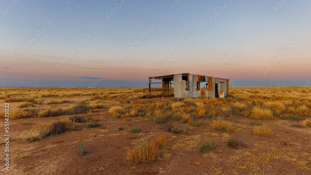 End of day landscape in McKinlay with abandoned buildings, Queensland, Australia
