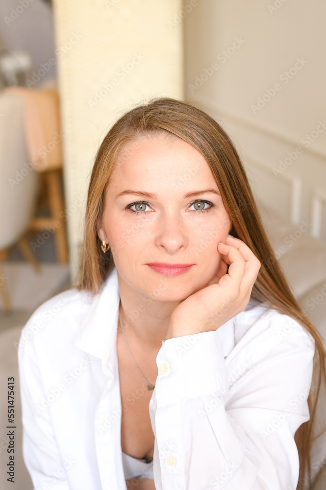 Portrait of middle-aged woman with long hair relaxing at home. Natural beauty concept. Vertical photo Portrait of middle-aged woman with long hair relaxing at home. Natural beauty concept. Vertical photo