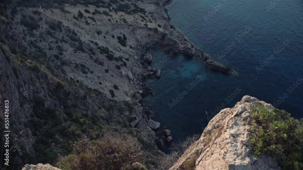 Looking down at the shoreline from the top of a cliff in Ibiza Looking down at the shoreline from the top of a cliff in Ibiza