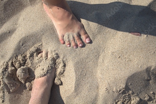 Feet in the sand in summer view from above