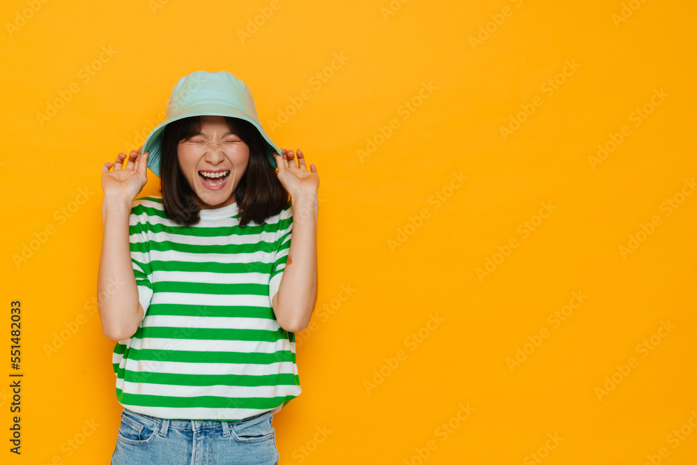 Asian young woman wearing panama laughing at camera Asian young woman wearing panama laughing at camera