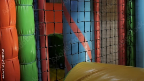 A little boy of 4 years old is playing in an entertainment complex, climbing various soft figures and going through mazes. Fun entertainment for children. High quality 4k footage photo