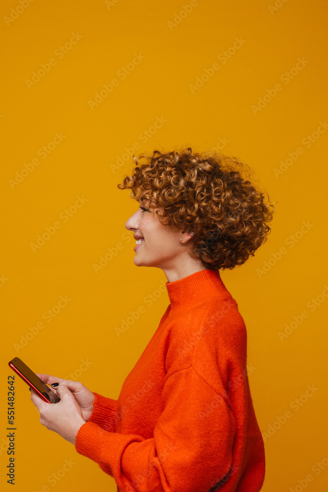 Profile of mature woman using smartphone while standing isolated Profile of mature woman using smartphone while standing isolated