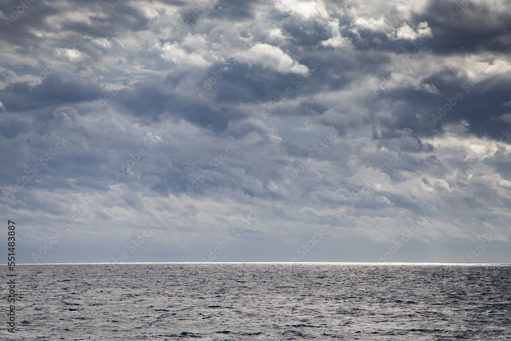 Fototapeta premium seascape with dark clouds and light