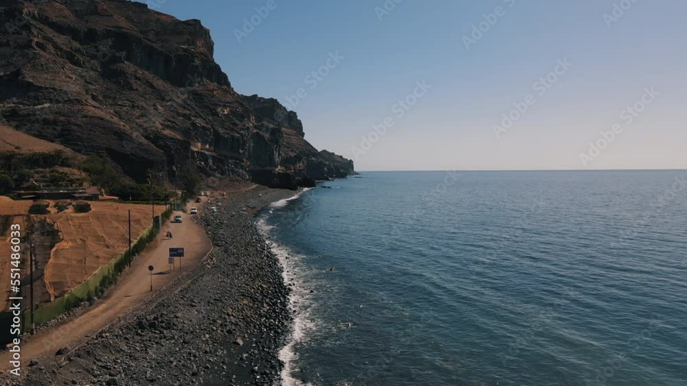 Panoramic shot over the Tasarte beach on the island of Gran Canaria and located in the Aldea de San Nicolas. On a sunny day. Panoramic shot over the Tasarte beach on the island of Gran Canaria and located in the Aldea de San Nicolas. On a sunny day.