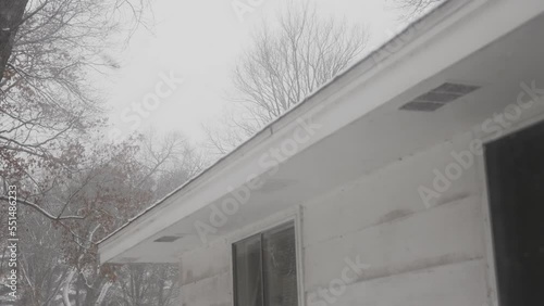 Slow motion of snow falling on a lake home in Michigan. photo