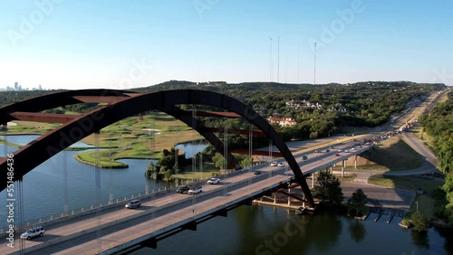 Aerial drone forward moving shot over Pennyback bridge in Austin, Texas, USA with a top down view of Lake Austin on a bright sunny day. photo