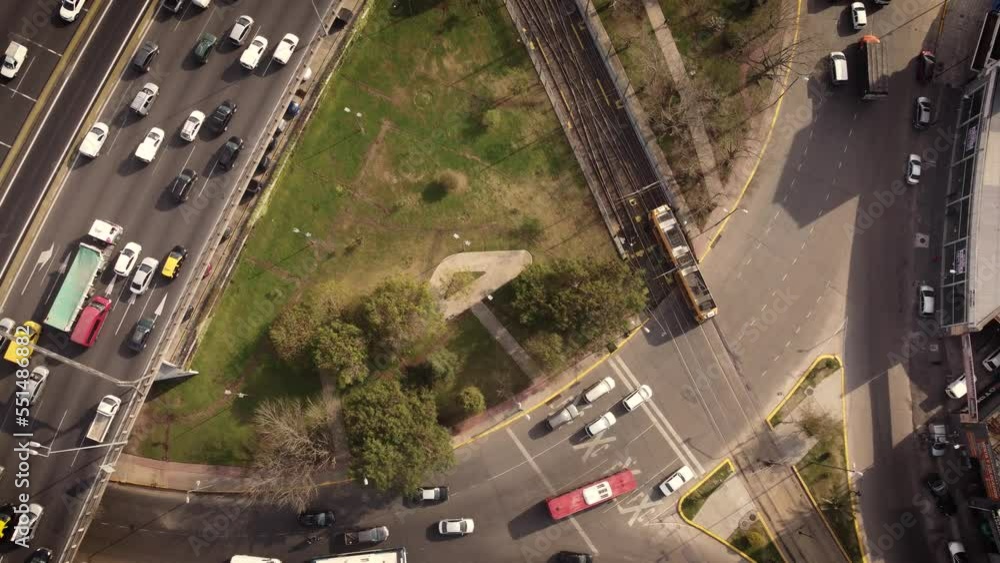 Aerial top view showing driving tram and cars on highway in Buenos Aires at sunset Aerial top view showing driving tram and cars on highway in Buenos Aires at sunset