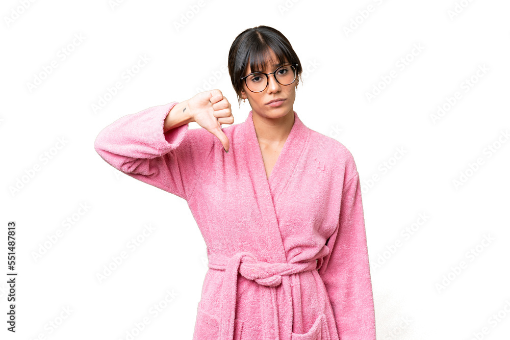 Young woman in bathrobe over isolated chroma key background showing thumb down with negative expression Young woman in bathrobe over isolated chroma key background showing thumb down with negative expression