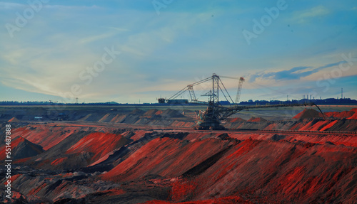 Landscape of industrial view of opencast mining quarry with machinery at work. Area has been mined for copper, silver, gold, and other minerals. Horizontal image.