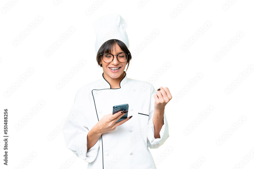 Young caucasian chef woman over isolated chroma key background with phone in victory position Young caucasian chef woman over isolated chroma key background with phone in victory position