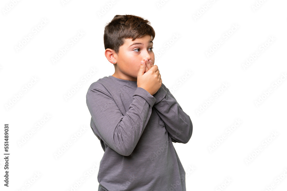 Little caucasian kid over isolated chroma key background covering mouth and looking to the side Little caucasian kid over isolated chroma key background covering mouth and looking to the side