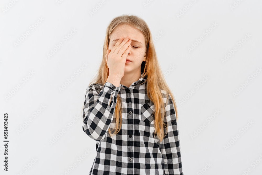 Portrait of pretty teen girl having headache. Young woman touches her head and grimaces from migraine, feels sick dizzy, stands over white background Portrait of pretty teen girl having headache. Young woman touches her head and grimaces from migraine, feels sick dizzy, stands over white background