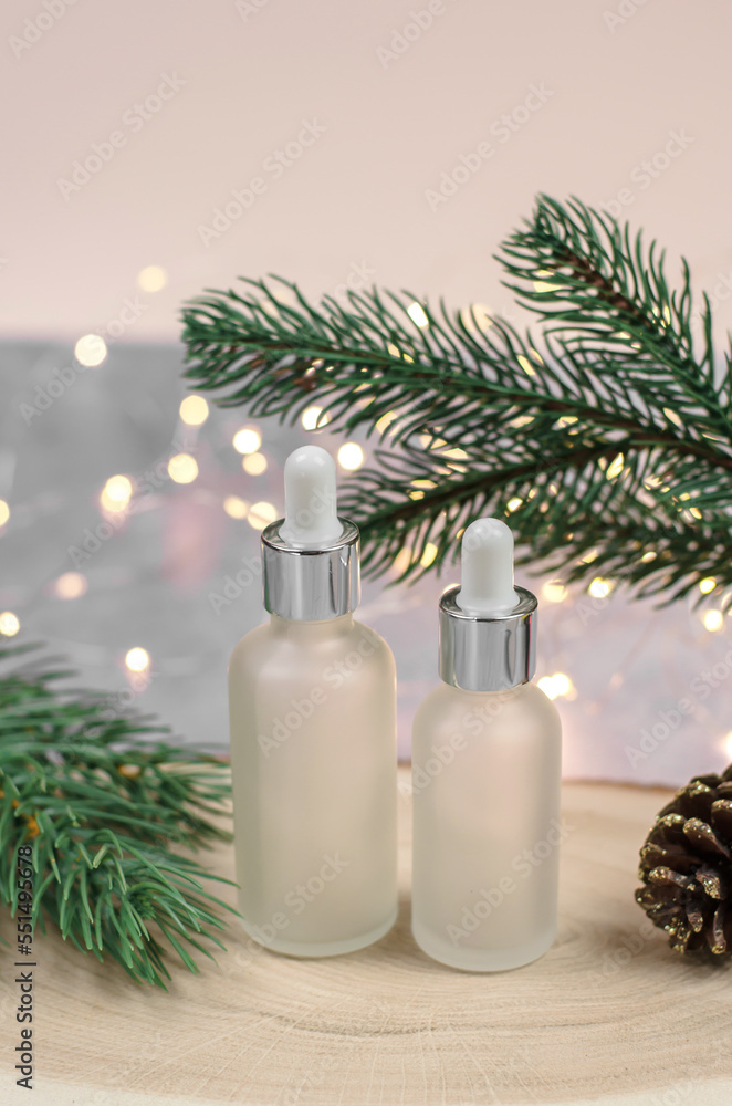 Bottle of essential oil or serum on Christmas background. Blank for christmas sales Bottle of essential oil or serum on Christmas background. Blank for christmas sales
