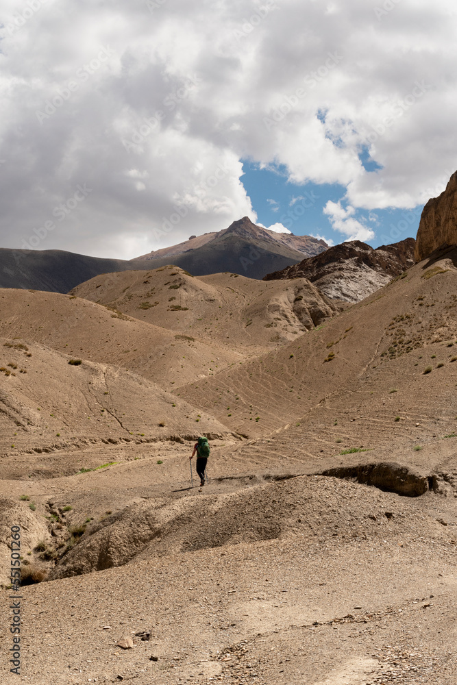 A lone climber walking in the mountains with backpacks. Small Himalayas A lone climber walking in the mountains with backpacks. Small Himalayas
