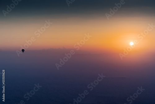 Hot Air Balloon above the clouds during sunrise in Dubai