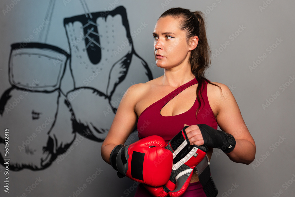 Portrait of a sporty woman with boxing gloves