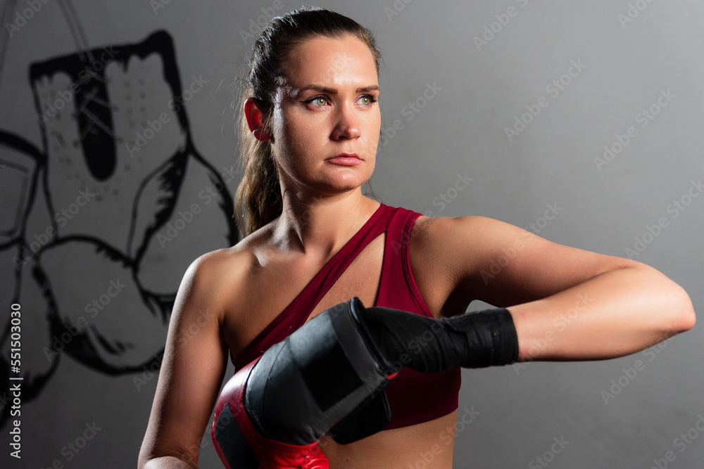 Portrait of an athletic woman in boxing gloves