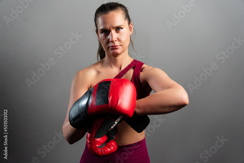 Portrait of an athletic woman in boxing gloves