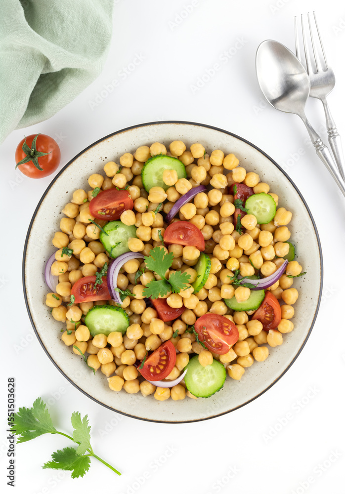 Chickpea salad with tomatoes, cucumber, onion and greens on a white background. Top view. Oriental and Mediterranean cuisine. Chickpea salad with tomatoes, cucumber, onion and greens on a white background. Top view. Oriental and Mediterranean cuisine.