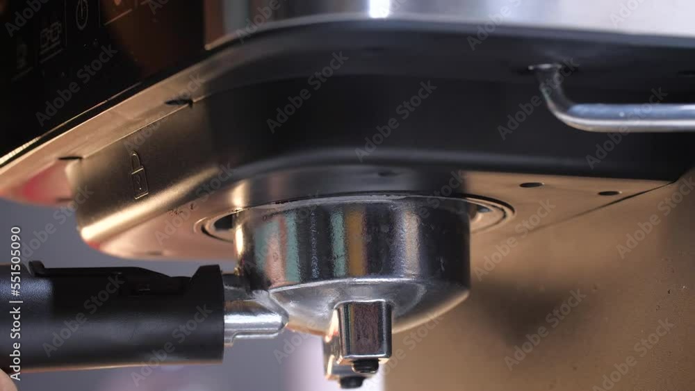 Close up shot filling the grinded coffee bean in to the coffee portafilter Close up shot filling the grinded coffee bean in to the coffee portafilter