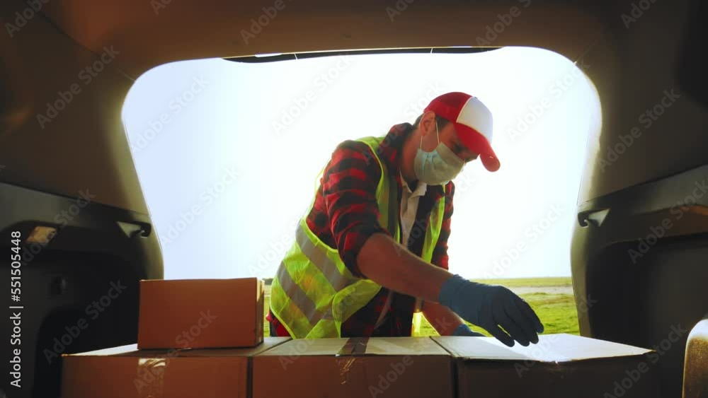 Delivery driver loading his van with boxes. Professional mover loads it ...
