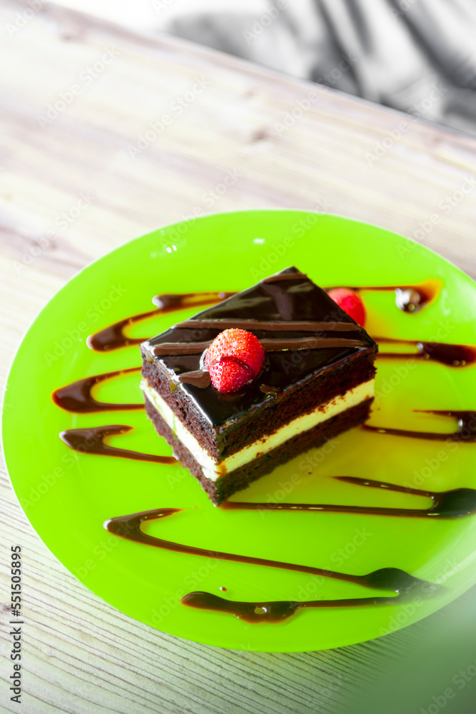 chocolate cake with strawberries on green plate chocolate cake with strawberries on green plate