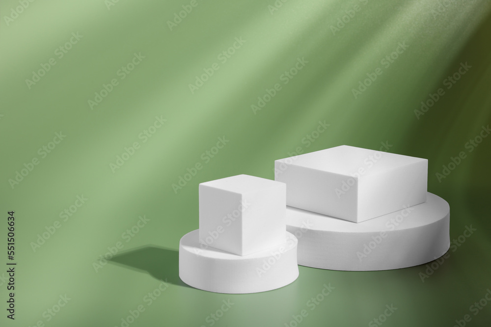 Product presentation scene. Podiums of different geometric shapes on pale light green background, space for text Product presentation scene. Podiums of different geometric shapes on pale light green background, space for text