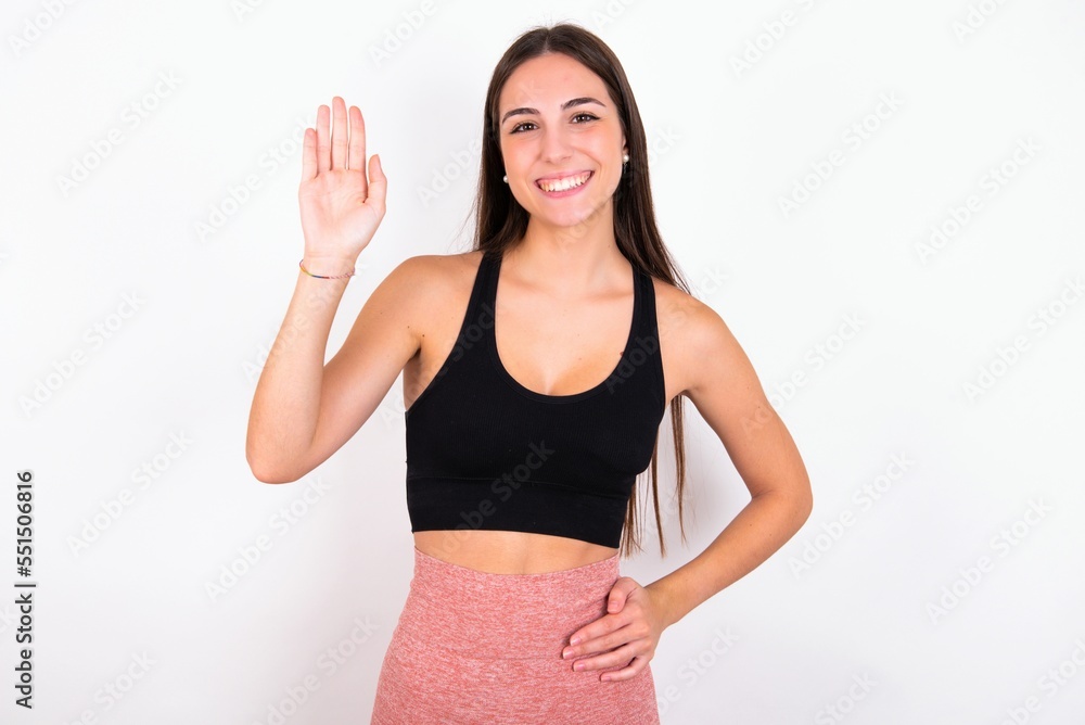 MODEL waiving saying hello or goodbye happy and smiling, friendly welcome gesture. MODEL waiving saying hello or goodbye happy and smiling, friendly welcome gesture.