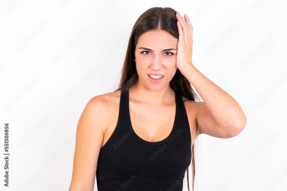 Portrait of confused Young caucasian woman wearing sportswear over white background holding hand on hair and frowning, panicking, losing memory. Worried and anxious can not remember anything. Portrait of confused Young caucasian woman wearing sportswear over white background holding hand on hair and frowning, panicking, losing memory. Worried and anxious can not remember anything.